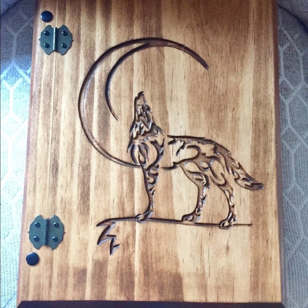 Wooden notebook with carved howling wolf